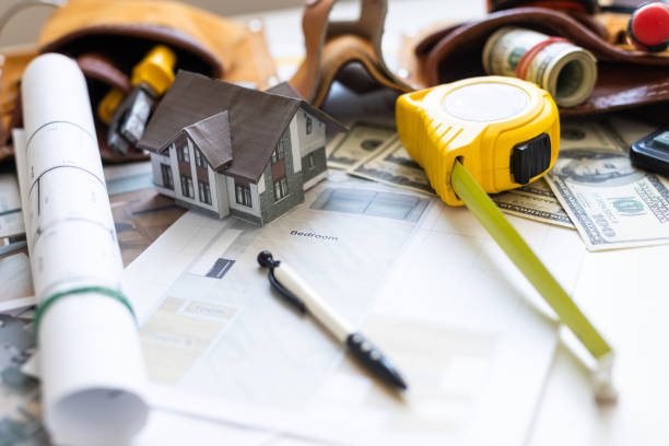 A model house on blueprints with keys to the new home Close up. High quality photo